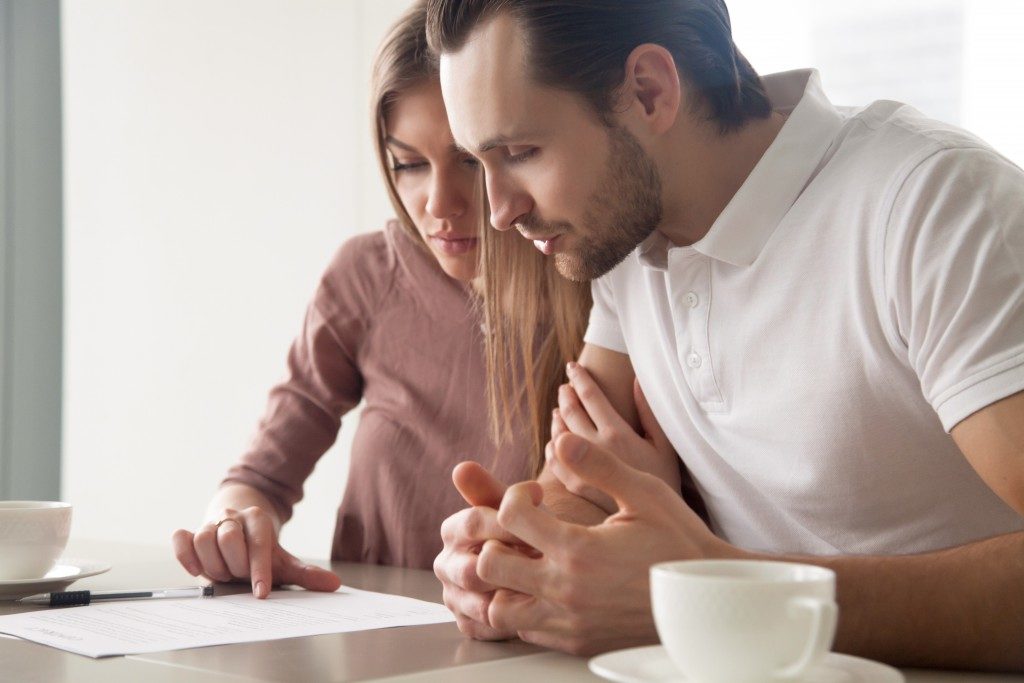 Couple reviewing a contract before finalizing a sale